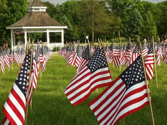 <img src="greatgetawayideasformemorialday.jpg" alt="American Flags at a Cemetery">