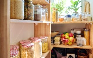 pantry shelves filled with items in glass jars on the shelves