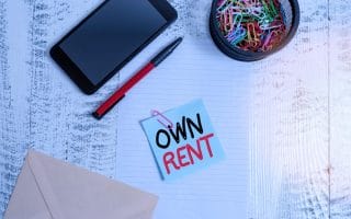 Picture of a post it note with the words "own" and "rent" on it