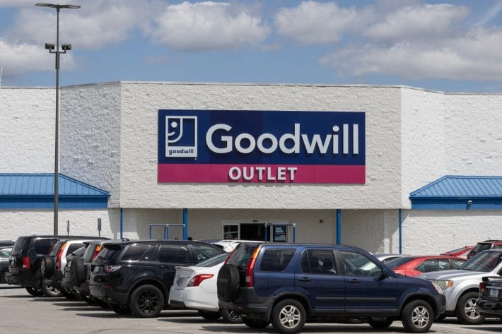 Goodwill location with cars in front of it. 