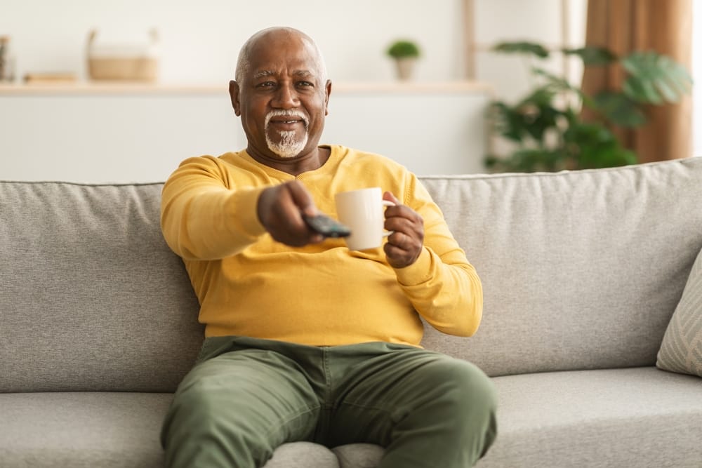 senior watching cable TV
