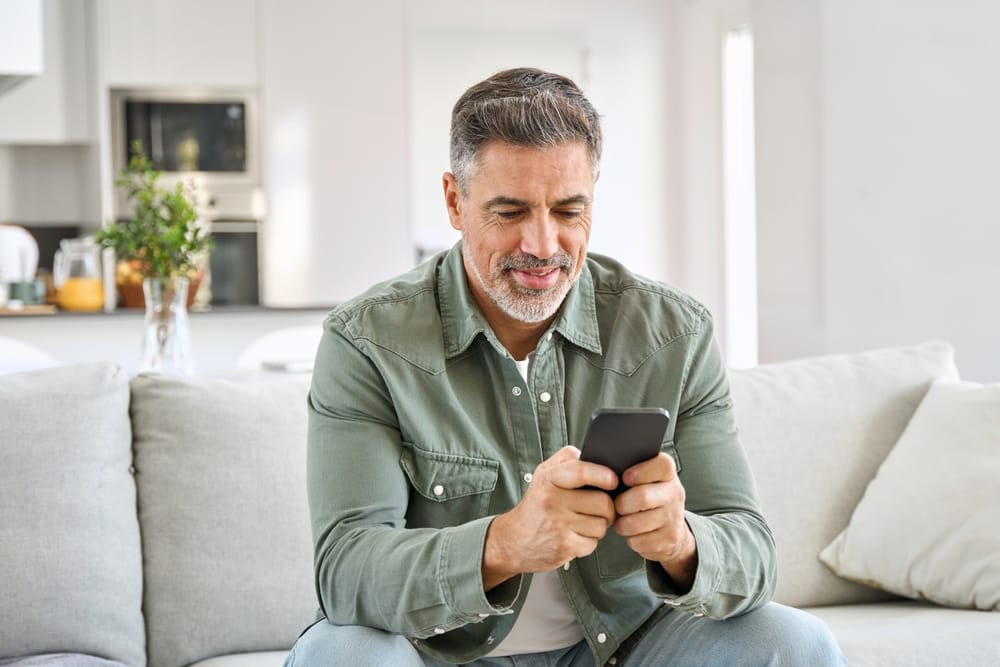 senior using online banking app to catch hidden bank fees